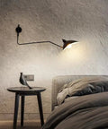 Mid-Century Black Wall Lamp With Industrial Swing Arm Dope Adjustable Wall Mount Lighting illuminating bedside table