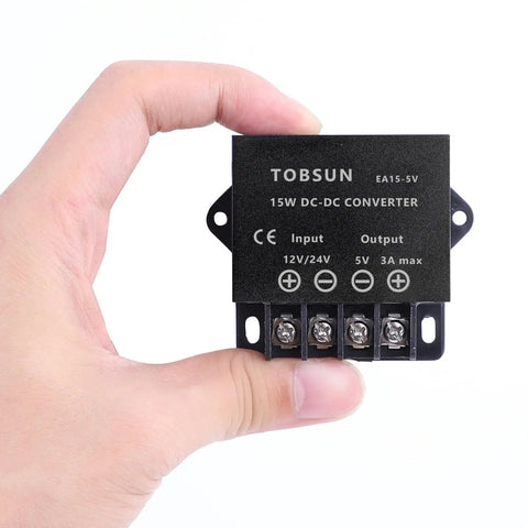 Person holding Input Range 12V To 24V To 5V 3A 15W DC Power Converter For Cars And Electronics No Fuss Step Down Regulator