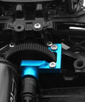 Close-up of TT02 Aluminum Open End Gearbox Cover installed on Tamiya RC car showing gear visibility and sleek blue finish.