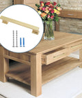 10 Pack 5 Inch Brushed Satin Brass Cabinet Handles, screws included, displayed on a wooden table in a living room setting