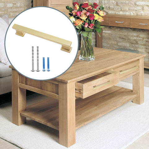 10 Pack 5 Inch Brushed Satin Brass Cabinet Handles, screws included, displayed on a wooden table in a living room setting