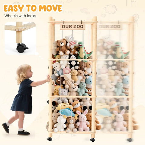 Child pushing extra large stuffed animal zoo organizer with wheels for kids rooms, filled with plush toys and labeled 'Our Zoo'.