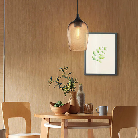 Amber pendant light over a dining table with black finish, showing Dope Two Pack One Light Pendant Lights For Kitchen Island In Indoor Dining.