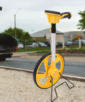 Digital Measuring Wheel for Versatile Professionals with yellow wheel and handle, adjustable length for accurate measurements.