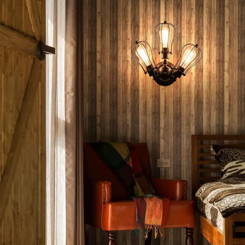 Vintage Industrial Ceiling Light With Metal Wire Cage Shade installed in cozy rustic bedroom setting.