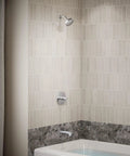 Bathroom with tub featuring Pitch Rite-Temp Bath And Shower Trim Set Without Showerhead in Matte Black with faceplate, handle, and spout.