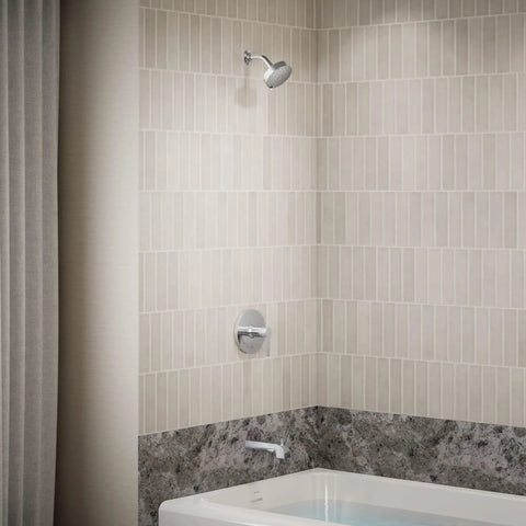 Bathroom with tub featuring Pitch Rite-Temp Bath And Shower Trim Set Without Showerhead in Matte Black with faceplate, handle, and spout.