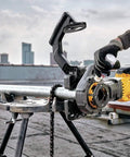 DeWalt Flexvolt 60V Max Brushless Pipe Threader Kit With Die Heads, cordless power tool used on a rooftop for threading metal pipes.