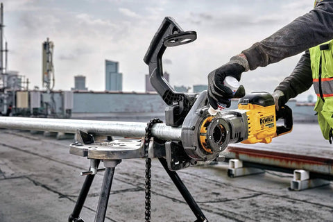DeWalt Flexvolt 60V Max Brushless Pipe Threader Kit With Die Heads, cordless power tool used on a rooftop for threading metal pipes.