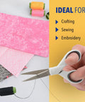 5 Inch Micro Tip Fabric Scissors with Titanium Bonded Blades for Precision Cuts, held alongside fabric and thread spools.