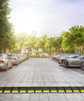 Heavy Duty Rubber Speed Bump 6.4 Ft Portable For Driveways And Roads on parking lot with cars and trees in background