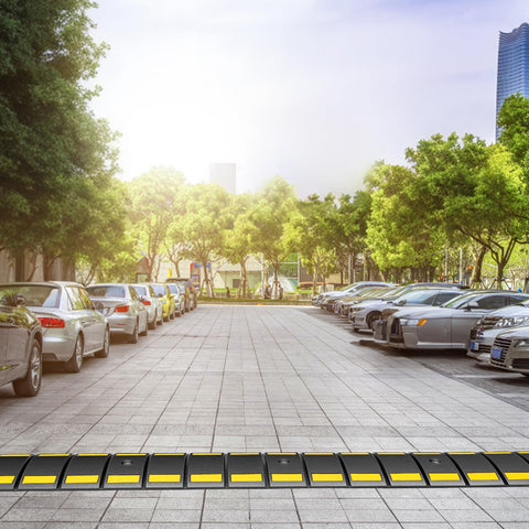 Heavy Duty Rubber Speed Bump 6.4 Ft Portable For Driveways And Roads on parking lot with cars and trees in background