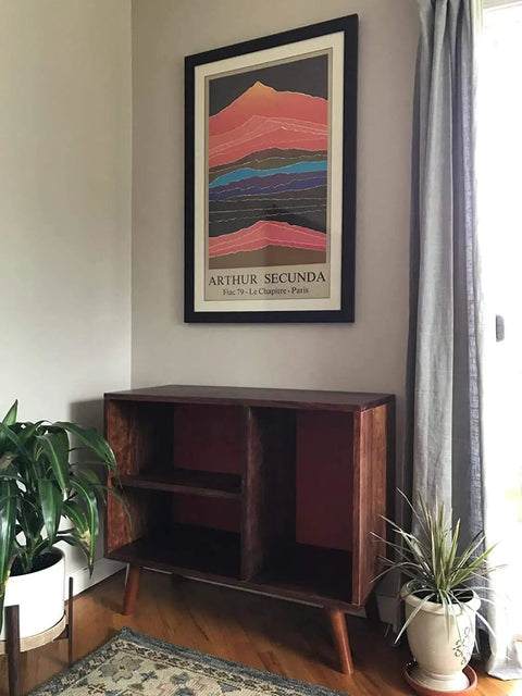 Mid-century modern cabinet with round solid wood furniture legs in a living room setting