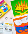 LilyPad Sewable Electronics Starter Kit with colorful mask templates, USB board, and instruction booklet on table.