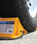 Camco wheel chock with rope, yellow plastic block for trailer tires up to 26 inches.