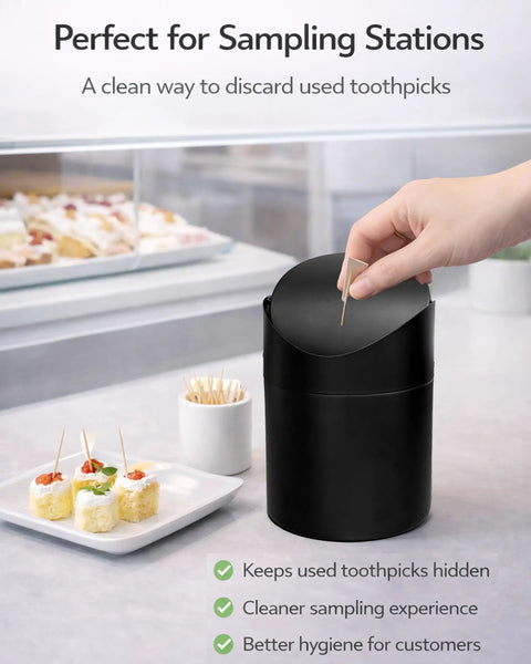 Hand using Tiny Matte Black Desktop Trash Can With Lid For Office Desk And Vanity 1.5 Liter Countertop Waste Bin