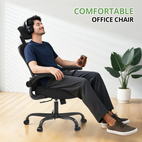 Person relaxing in an ergonomic desk chair for long hours with high back and plush lumbar support, flip up armrests, rolling swivel, black.