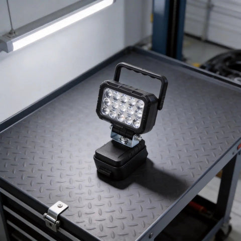 ABS Flood Light 15 LEDs Compatible with 18V Li-Ion Packs on a metal workbench, showcasing its sturdy design and functionality.