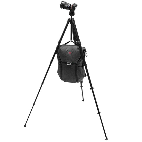 Carbon Fiber Travel Tripod With Pro Level Stability, Fast Setup And Takedown, Ergonomic Ball Head, Ultra Compact And Portable For Camera And Phone, 20 Pound Load Capacity supporting camera and bag.