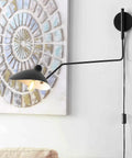 Industrial Black Plug In Swing Arm Wall Sconce With Adjustable Shade And E26 Socket On Off Switch Indoor Reading Light For Bedroom Bedside Wall Mounted Lamp installed near decorative wall art.