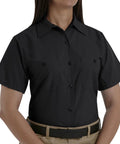 Top Shelf Heavy Duty Short Sleeve Industrial Work Utility Button Down Uniform Shirt With Soil Release Finish And Moisture Wicking Fabric Dual Chest Pockets Relaxed Fit Matte Black on female model.