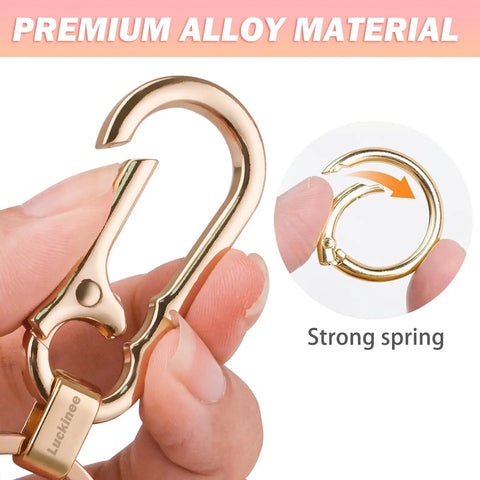 Close-up of Two Pack Metal Keychains With Carabiner Clip And Dual Key Rings Anti Lost Quick Release Key Clip in hand, showing strong spring.