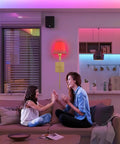 Living room with Wireless Battery Operated Wall Sconce Set Of 2 With Remote, gold finish, emitting soft LED light.