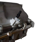 ICT Billet vacuum port adapter installed on LS supercharger; aluminum body with black hose barb, 1/8 NPT port