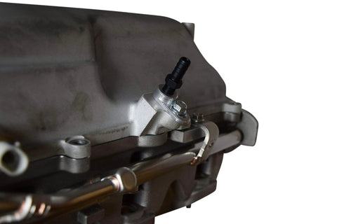 ICT Billet vacuum port adapter installed on LS supercharger; aluminum body with black hose barb, 1/8 NPT port