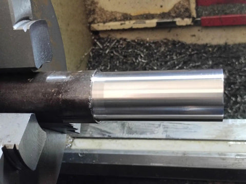 Metal rod on lathe showing smooth finish with Turning And Facing Lathe Tool Holder Set For Quick Change Tool Post Includes Four Tool Holders And One Lathe Burnishing And Rolling Tool For Smooth Surface Finish And Precision Turning Without Grinding.