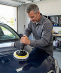 Man using a 6 Piece 6 Inch Wool Polishing Pad Kit With M14 Drill Adapter And Hook And Loop Backing Pad for car detailing in garage