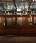 Interior barn roof with Double Sided Reflective Aluminum Foil Insulation Roll For Heat Shield And Radiant Barrier, lit by string lights.