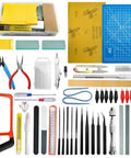 85 Piece Model Tools Kit For Hobbyists And Beginners includes sandpaper, cutting mat, pliers, tweezers, knives, and files.
