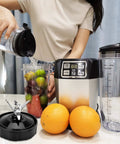 Person using blender with 7 Fin Blender Blade Replacement Compatible With Auto IQ Blenders, fruits, and oranges nearby.