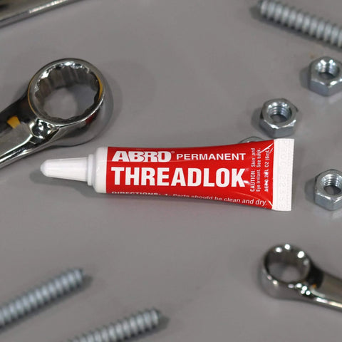 Heavy Duty Red Threadlocker High Strength Industrial Grade Adhesive Built For Automotive And Manufacturing Keeps Fasteners Tight Against Vibration And Heat Permanent Bond And High Temperature Resistance tube with bolts and wrenches