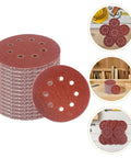 Pro Grade 150 Pack Round Sanding Discs 5 Inch Hook And Loop Replacement Pads stacked with one disc showing holes for dust extraction.