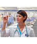 Doctor writing on transparent dry erase board in hospital room with medical schedule visible.