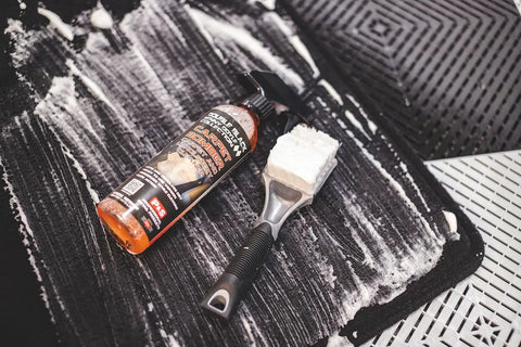 Carpet Bomber Upholstery Cleaner Citrus Power That Lifts Grease Dirt And Odors Tough Grime Be Gone shown cleaning car mat