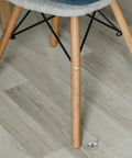 Close-up of a chair leg next to 10 Pack Screw On Iron Furniture Feet M6 For Beds Couches Tables And Dressers White Simple Classic Decorative Legs