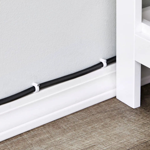 Round Cable Wire Clips Set For Wall Mounting And Cable Management, black cable secured with white clips on baseboard