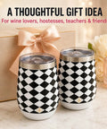Premium Double Wall Insulated Stemless Wine Tumblers With Slider Lids 12 Oz Set on a table beside a gift box and flowers.