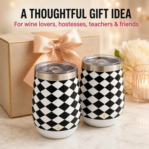 Premium Double Wall Insulated Stemless Wine Tumblers With Slider Lids 12 Oz Set on a table beside a gift box and flowers.