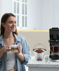 Woman enjoying coffee with Stainless Steel Reusable Coffee Filter For Ninja And Most Coffee Makers Includes Four Cone Filters.