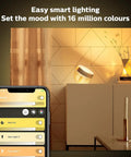 Gold Smart Table Lamp With White And Color Ambiance LED That Changes Color on a sideboard, smartphone app control visible