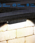 8 Pack 7 Inch LED Hardscape Lights with 270 Degree Adjustable Step and Wall Lighting illuminating outdoor brick wall in rain