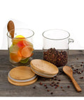 Keep Your Daily Grind Hella Fresh In This Rock Solid Clear Glass Coffee Canister And Airtight Food Storage Jar With Tightly Sealed Lid And Handy Spoon For Tea Sugar Salt Organization on wooden surface.