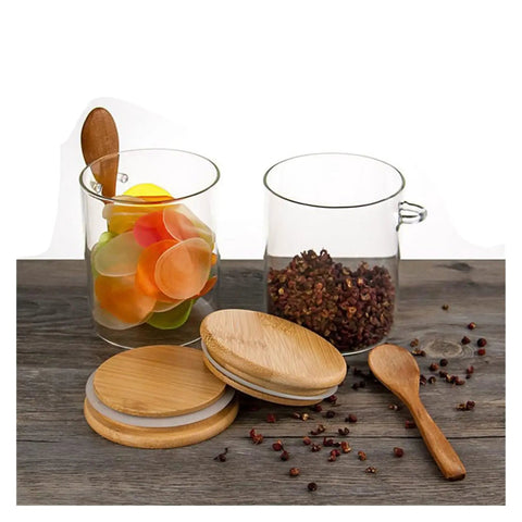 Keep Your Daily Grind Hella Fresh In This Rock Solid Clear Glass Coffee Canister And Airtight Food Storage Jar With Tightly Sealed Lid And Handy Spoon For Tea Sugar Salt Organization on wooden surface.