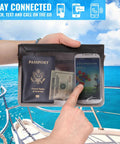 Hand holding Killer Waterproof Fanny Pack Phone Pouch Dry Bag on boat with phone, passport, and cash inside.