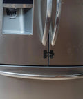 Four Pack Kid Safe Refrigerator And Oven Locks For Cabinets And Drawers, Easy Snap On Safety Latches with no tools needed shown on fridge