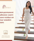 Woman walking on stairs with Non Slip Indoor Stair Treads Set Of 13 In Grey With Self Adhesive Peel And Stick 30 By 8 Inch Mats.
